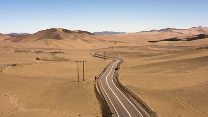 Aerial dollly in over an asphalt road in Atacama Desert, nearby Copiapo, Chile