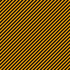 Orange and black diagonal lines. Simple seamless pattern in Halloween colors. Repeating complementary background for wrapping paper, textile, fabric. Endless backdrop