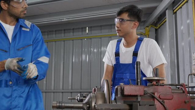 Supervisor training with young man sanding or iron and mistake while angry at industrial factory, mechanic working job while polish metal, male upset labor, labor and steelworks, industry concept.