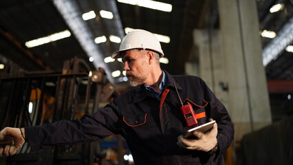 Man engineer standing on construction site or equipment maintenance work site.