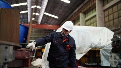 Man engineer standing on construction site or equipment maintenance work site.