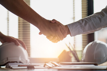 Engineer constructor handshake meeting with architect owner for agreement in contract building home project
