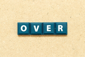 Tile alphabet letter in word over on wood background