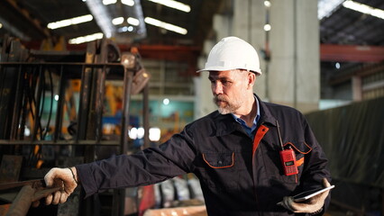 Fototapeta na wymiar Man engineer standing on construction site or equipment maintenance work site.