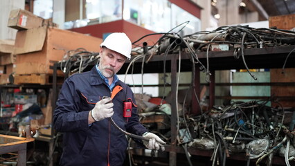 Man engineer standing on construction site or equipment maintenance work site.
