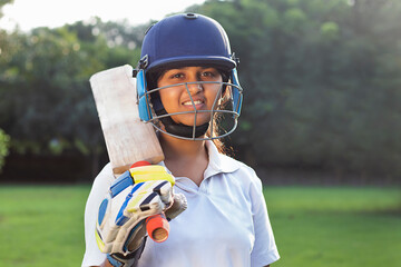 Portrait Of A Female Cricketer Holding A Cricket Bat