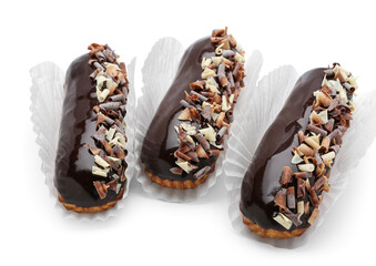 Delicious chocolate eclairs on white background