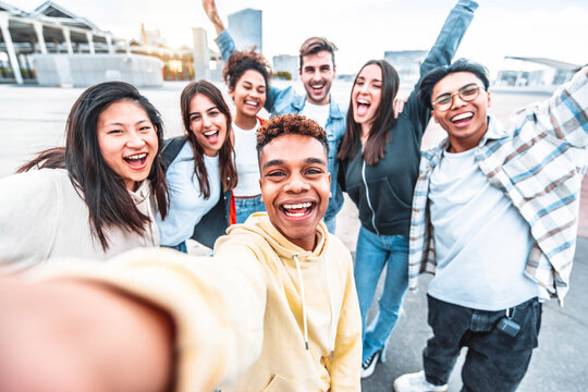 Multicultural happy friends having fun taking selfie picture on city street - Millennial people hanging outside on a sunny day - Youth community and friendship concept