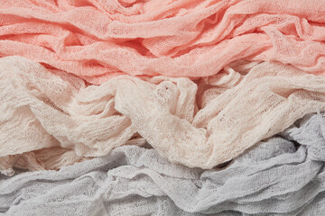 Folded cotton gauze fabric. Dyed pink, grey, coral gauze fabric