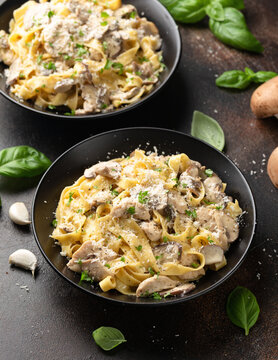 Creamy Alfredo pasta with chicken, mushrooms and parmesan cheese. Healthy Italian food