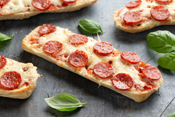 Pizza sandwiches with tomato sauce, mozzarella, pecorino cheese and salami