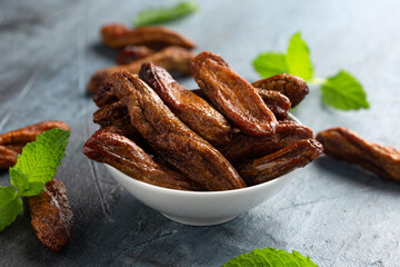 Sun dried bananas, healthy vegan vegetarian food snack concept.