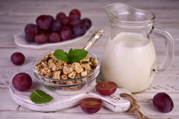 Granola with raisins and milk on a white background.Healthy breakfast.

