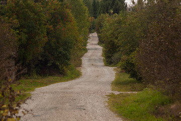 Road with unpaved surface.