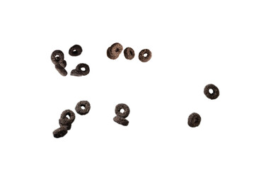 Chocolate rings cereal spill out into a bowl. Breakfast.