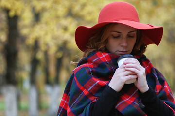 Young beautiful mother with her daughter on nature. A girl in a hat walks in the park. Girl in...
