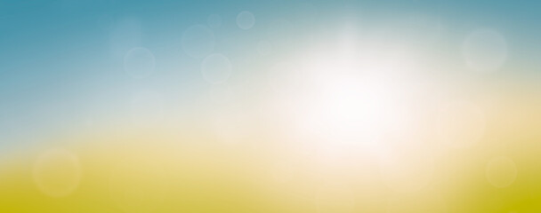 A fresh spring or Summer blue sunny sky background with blurred warm sunny glow.