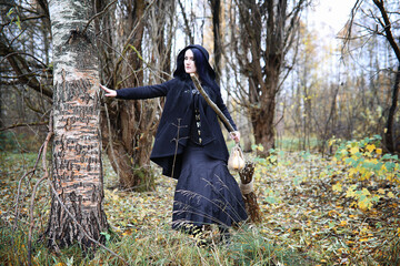 A woman in a witch suit in a forest