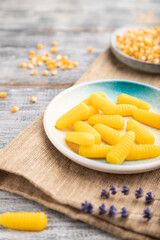Jelly corn candies on gray wooden background. close up, side view, selective focus.