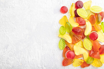 Various fruit jelly candies on gray concrete background. copy space, top view.