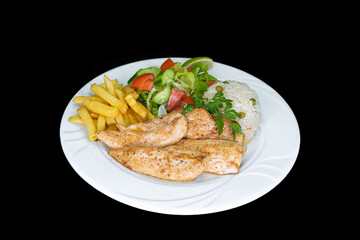 Grilled chicken fillets with rice, salad and french fries in a white plate