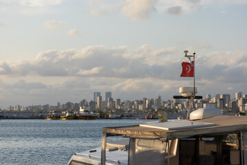 Turkish flag, on a red background white star and moon. Flag flies in the wind against the backdrop...
