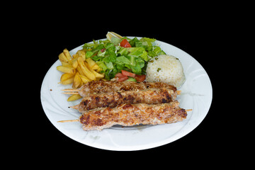 Grilled chicken Adana with rice, salad and french fries in a white plate