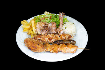 Grilled chicken fillet with rice, salad and french fries in a white plate