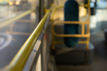 Handrail in bus. Yellow handrail. Interior of public transport.