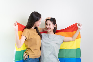 Obraz premium lesbian gay lover couple holding a gay flag isolated on background banner size
