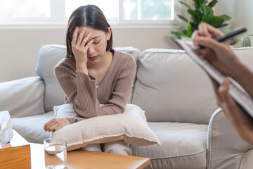 Young woman in a mental therapy session talking with a psychologist in the office.
