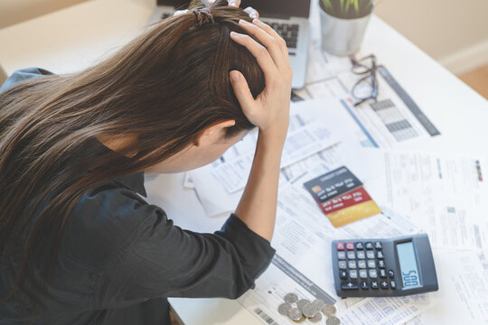 Stressed Young Asian Woman Trying To Find Money To Pay Credit Card Debt.