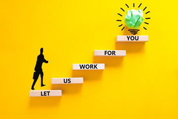 Let us work for you symbol. Concept words Let us work for you on wooden blocks. Businessman icon. Beautiful yellow table yellow background. Business and let us work for you concept. Copy space.