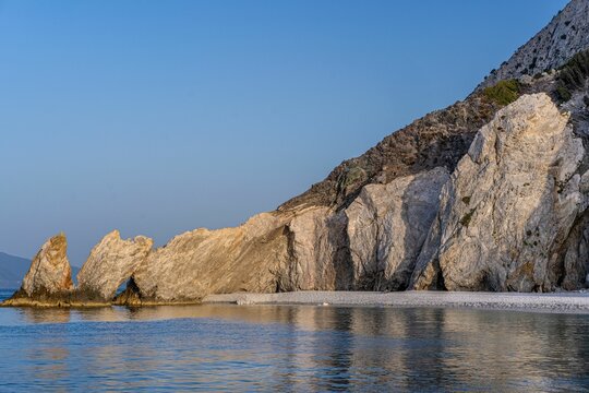 Breathtaking shot of the calm sea and rocky Lalaria beach during sunset, Skiathos island Greece
