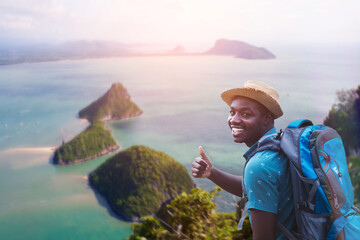 African traveler man with backpack stands on top group of island view beautiful nature scenic...