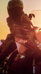 Woman in a helmet on a motorcycle at sunset