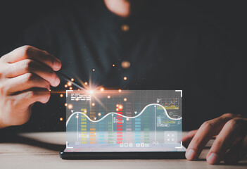 Graphs and Charts show on on tablet Screen.Investor analyzing financial reports of stock trading.Investor analyzing financial reports of stock trading