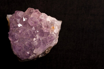 Druse of lavender amethyst on a black background.