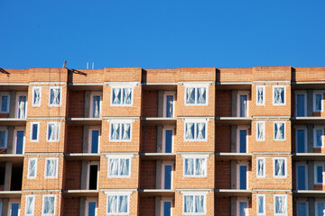 Unfinished tall building against the blue sky