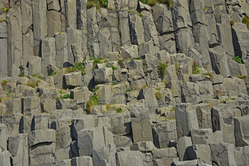 Basalt columns on Reynisfjara black volcanic sand beach in iceland by the ocean