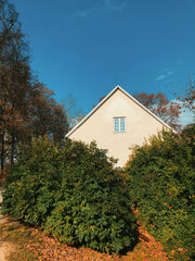 White house in the autumn forest in Sigulda