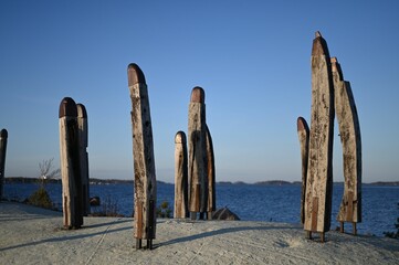 Historic mystic poles standing on the rocks near the Baltic Sea