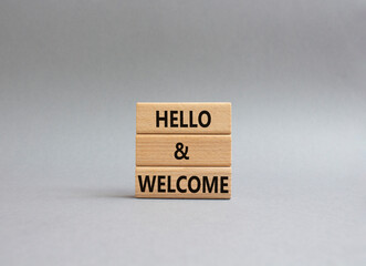 Hello and Welcome symbol. Concept words Hello and Welcome on wooden blocks. Beautiful grey background. Business and Hello and Welcome concept. Copy space.