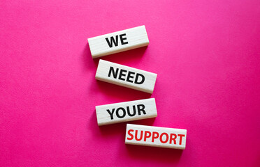 We need your support symbol. Wooden blocks with words We need your support. Beautiful red background. Business and We need your support concept. Copy space.