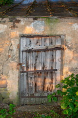 old wooden door of an outbuilding under lock and key
