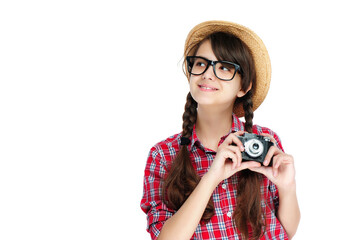 Girl in a straw hat holding the photo camera looking to the side