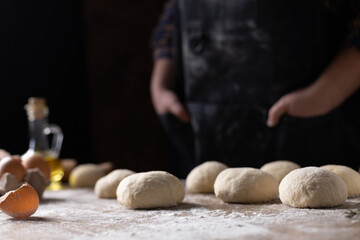 Chef kneading dough bread or pizza for homemade cooking at table
