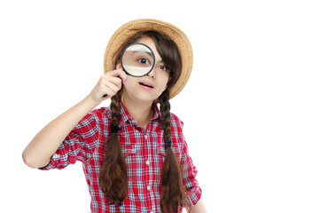 Teen girl looking though the magnifier against white background