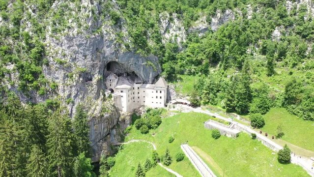 Predjama Castle - Postojna Cave Park Slovenia castle hidden in a cave rock Aerial shot drone 4k full hd landscape view europe historical 
