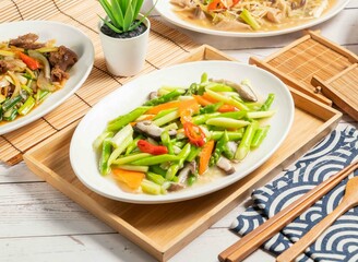 Fresh Fried Asparagus served in a dish isolated on wooden tray and napkin side view of taiwan food